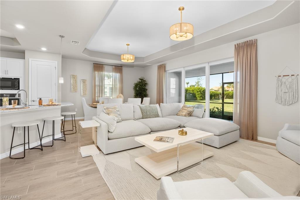 15048 Redbud Lane Punta Gorda, FL 33955 - Photo 4 of 34 a living room with furniture and a chandelier