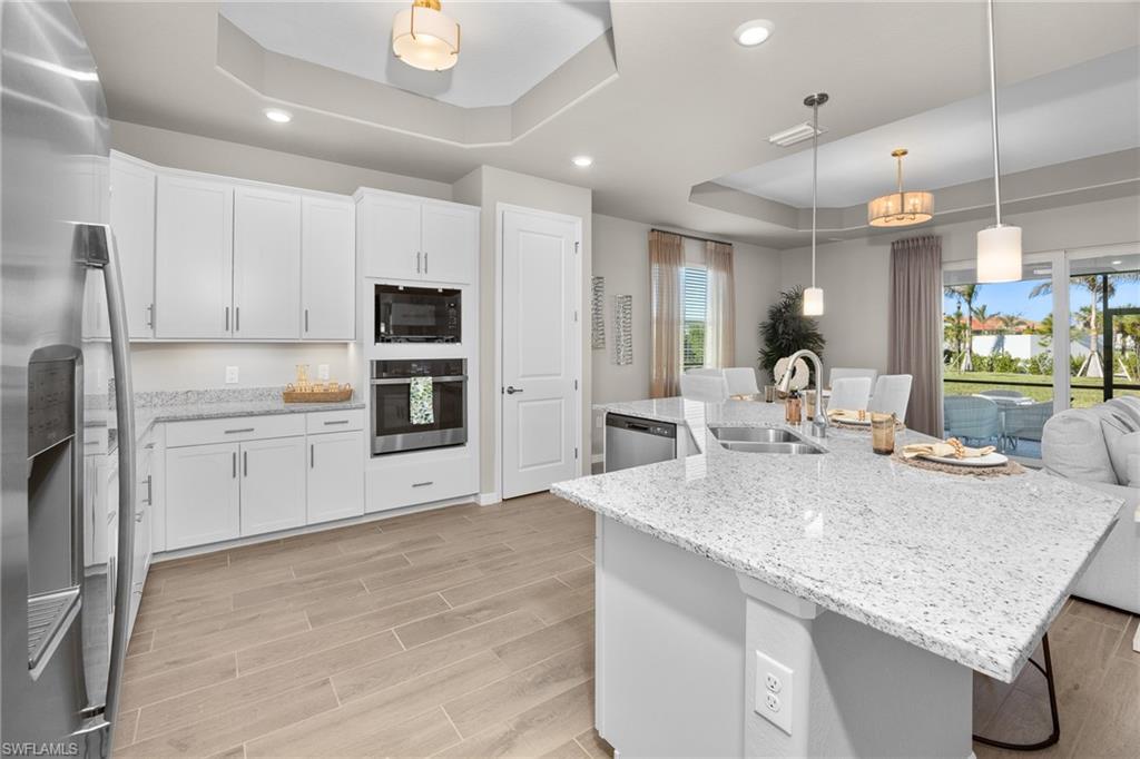 15048 Redbud Lane Punta Gorda, FL 33955 - Photo 8 of 34 a kitchen with stainless steel appliances granite countertop a sink refrigerator and cabinets