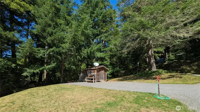a view of roof deck with chairs and wooden fence