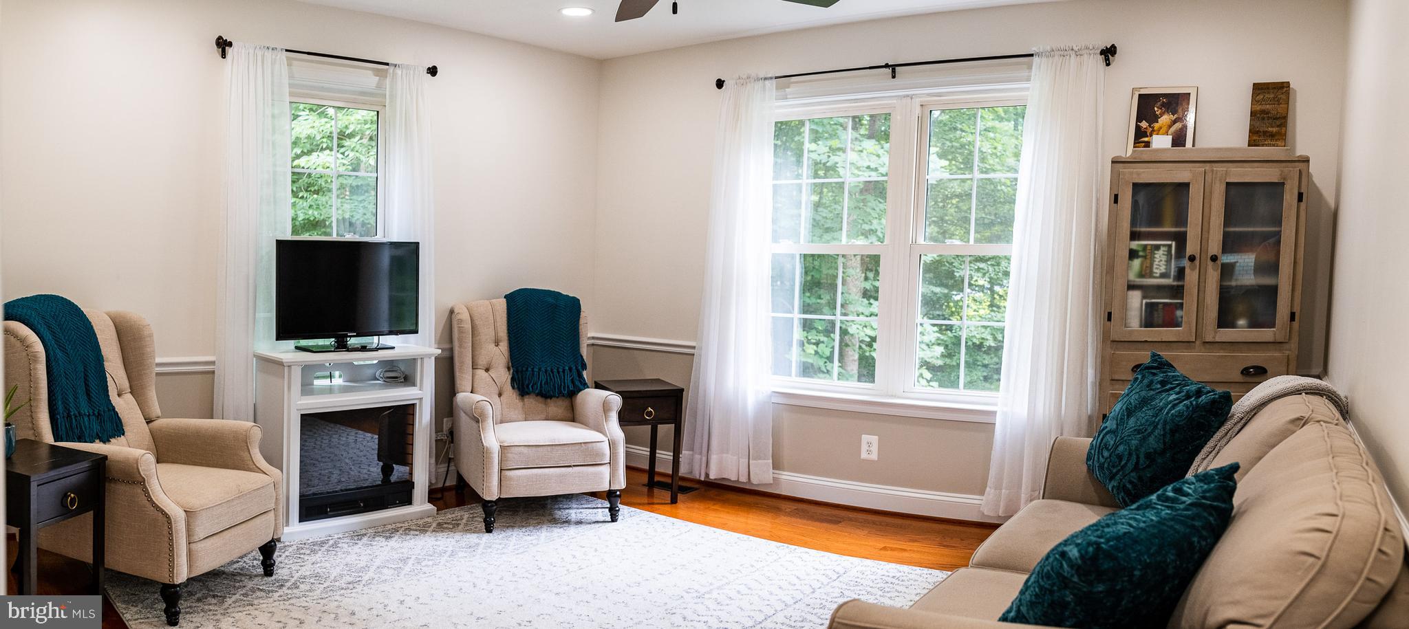 625 Carson Road Huntingtown, MD 20639 - Photo 4 of 21 a living room with furniture a window and a fireplace