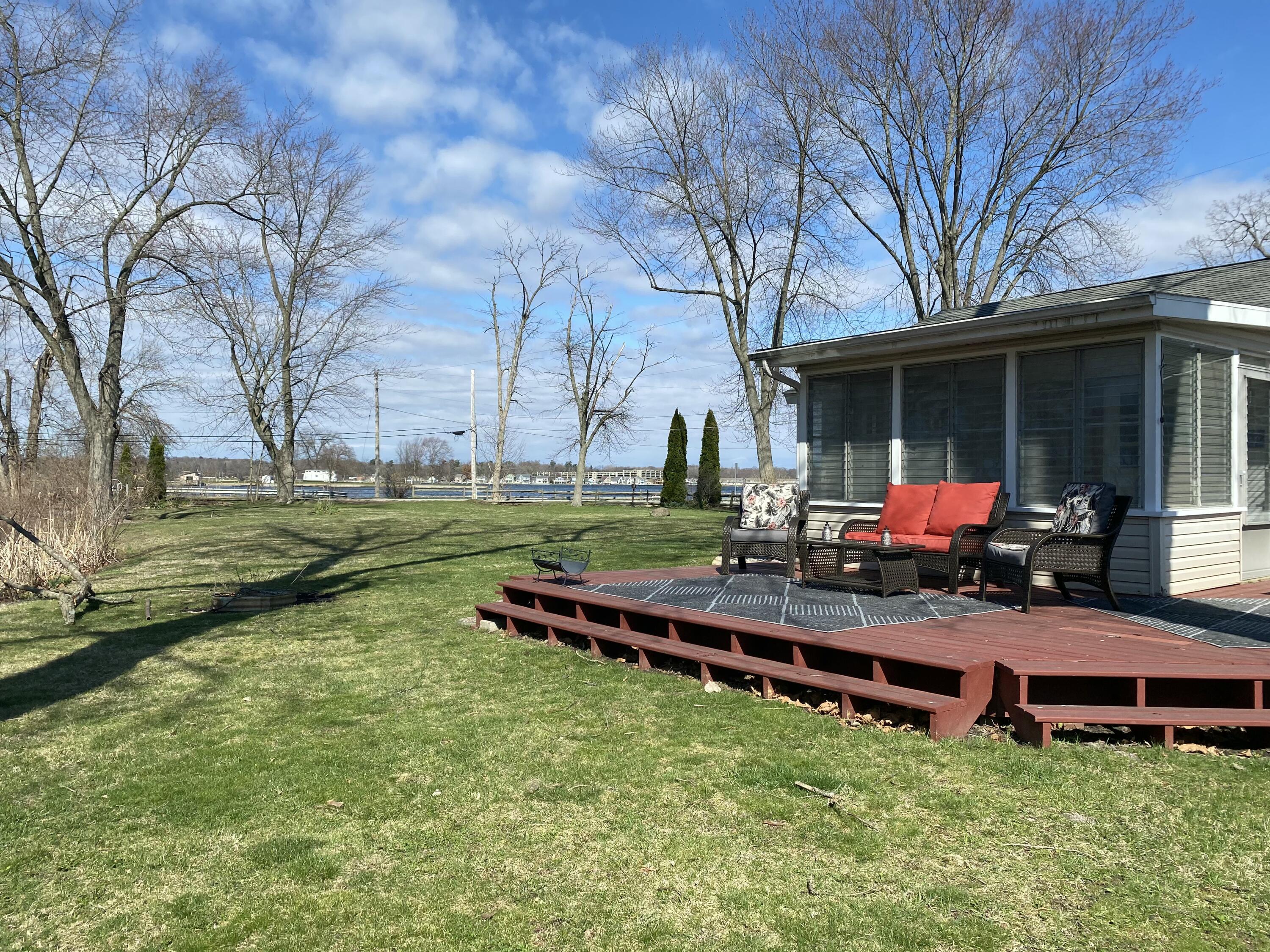 292 Grayson Road La Porte, IN 46350 - Photo 1 of 27 a wooden bench sitting in middle of the park
