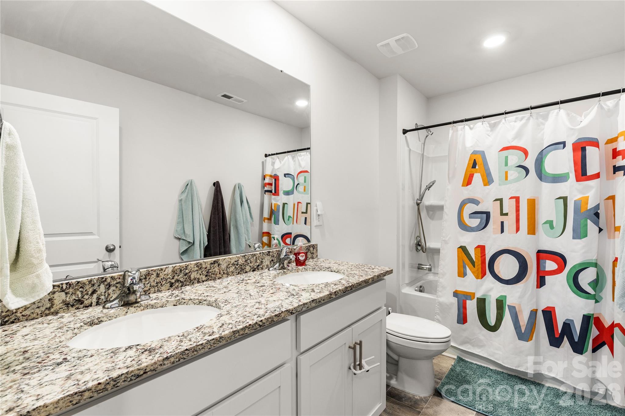 559 King Clover Lane Clover, SC 29710 - Photo 26 of 34 a bathroom with a sink a toilet and a mirror