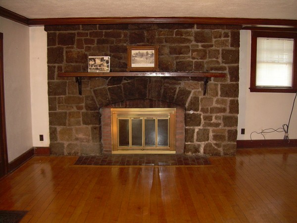 a view of a fireplace with wooden floor