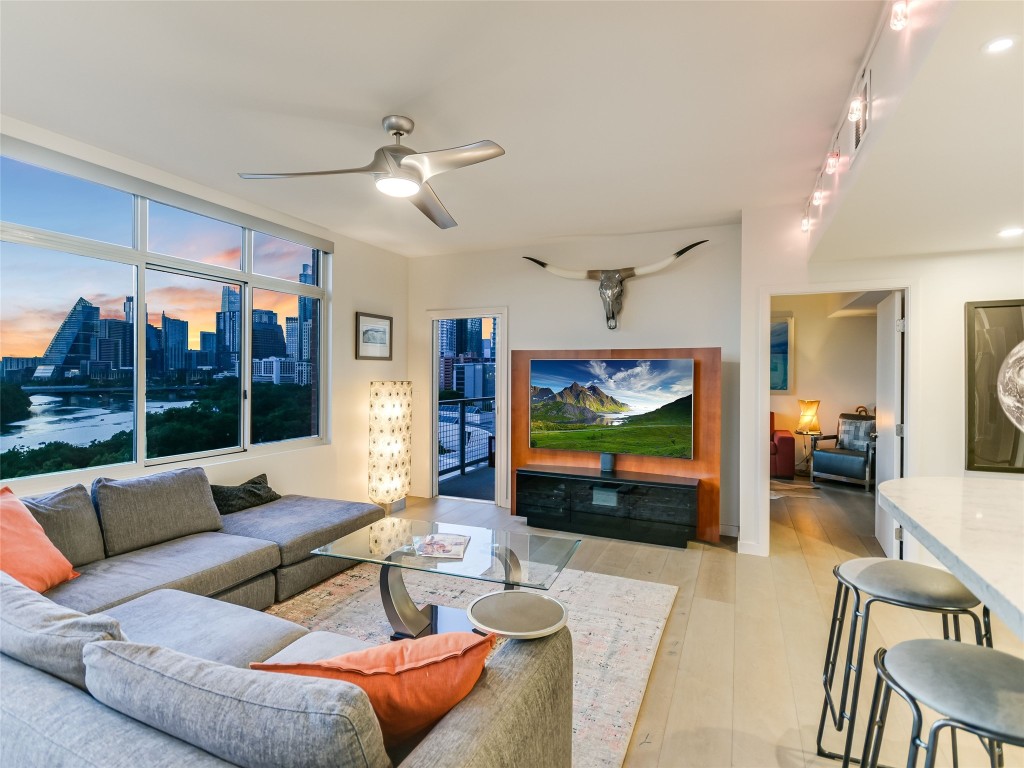 54 Rainey Street, Unit 922 Austin, TX 78701 - Photo 4 of 24 a living room with furniture and a flat screen tv