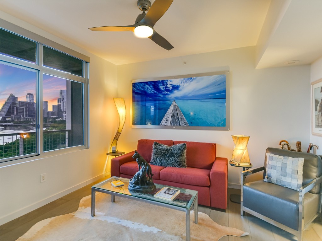 54 Rainey Street, Unit 922 Austin, TX 78701 - Photo 9 of 24 a living room with furniture and a floor to ceiling window