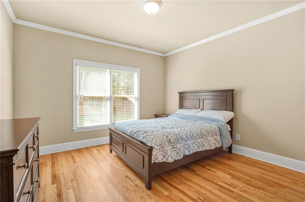 955 Gardiner Circle Suwanee, GA 30024 - Photo 16 of 44 a bedroom with a bed and wooden floor