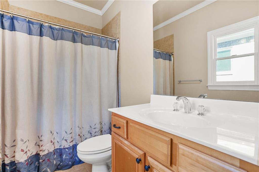 955 Gardiner Circle Suwanee, GA 30024 - Photo 17 of 44 a bathroom with a sink a toilet and a mirror