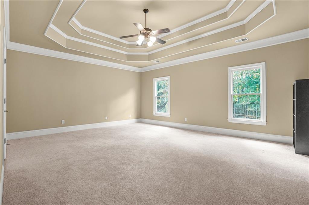 955 Gardiner Circle Suwanee, GA 30024 - Photo 22 of 44 an empty room with windows and ceiling fan