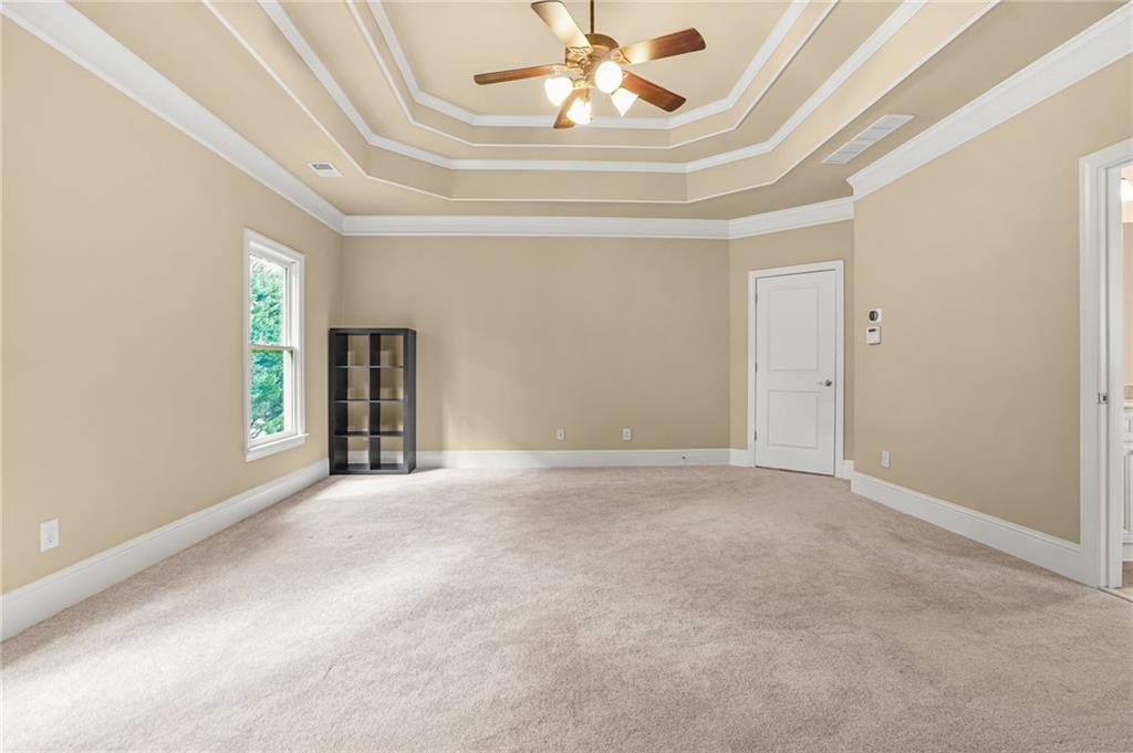 955 Gardiner Circle Suwanee, GA 30024 - Photo 23 of 44 an empty room with a ceiling fan and window
