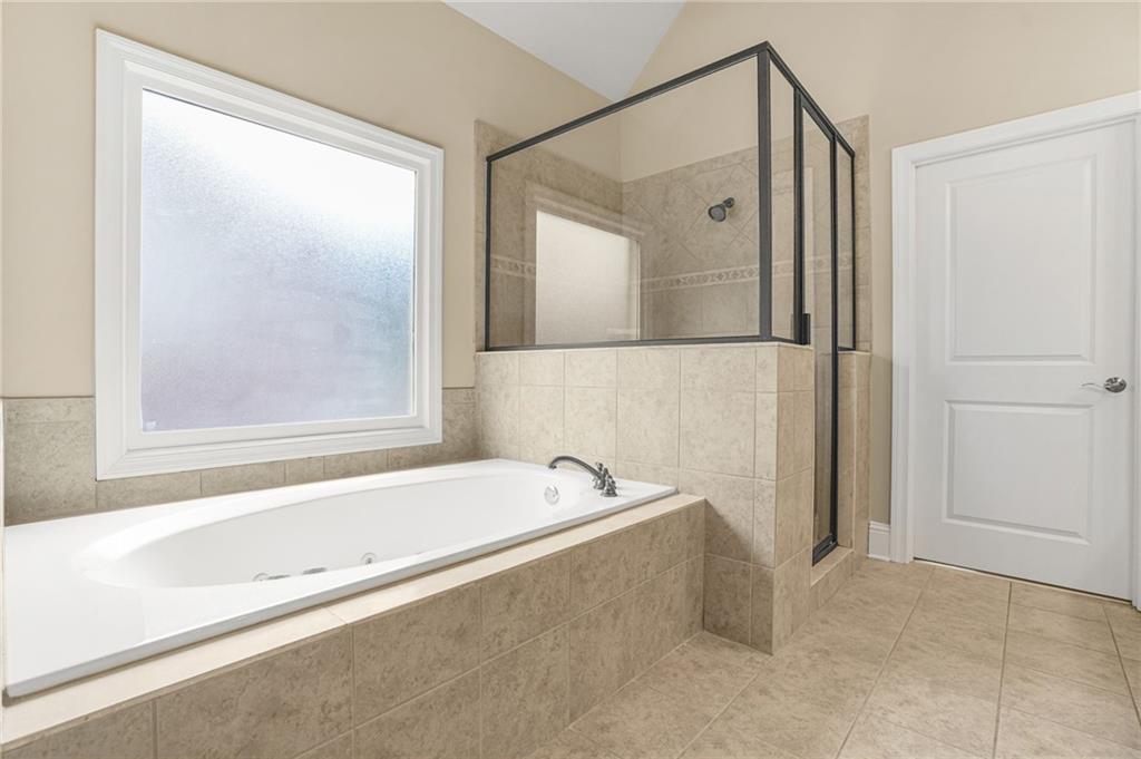 955 Gardiner Circle Suwanee, GA 30024 - Photo 25 of 44 a bathroom with a bathtub and a shower