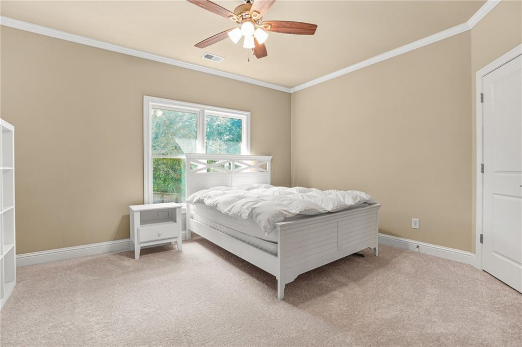 955 Gardiner Circle Suwanee, GA 30024 - Photo 27 of 44 a bedroom with a bed and window