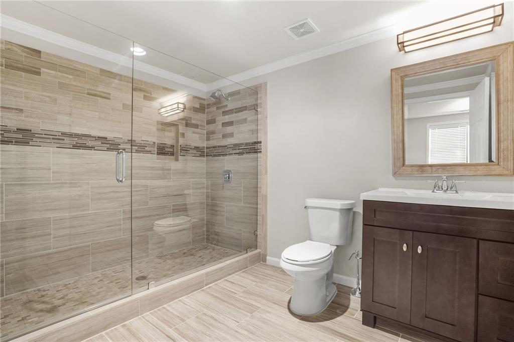 955 Gardiner Circle Suwanee, GA 30024 - Photo 38 of 44 a bathroom with a toilet a sink and shower