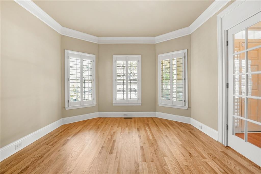 955 Gardiner Circle Suwanee, GA 30024 - Photo 4 of 44 an empty room with wooden floor and windows
