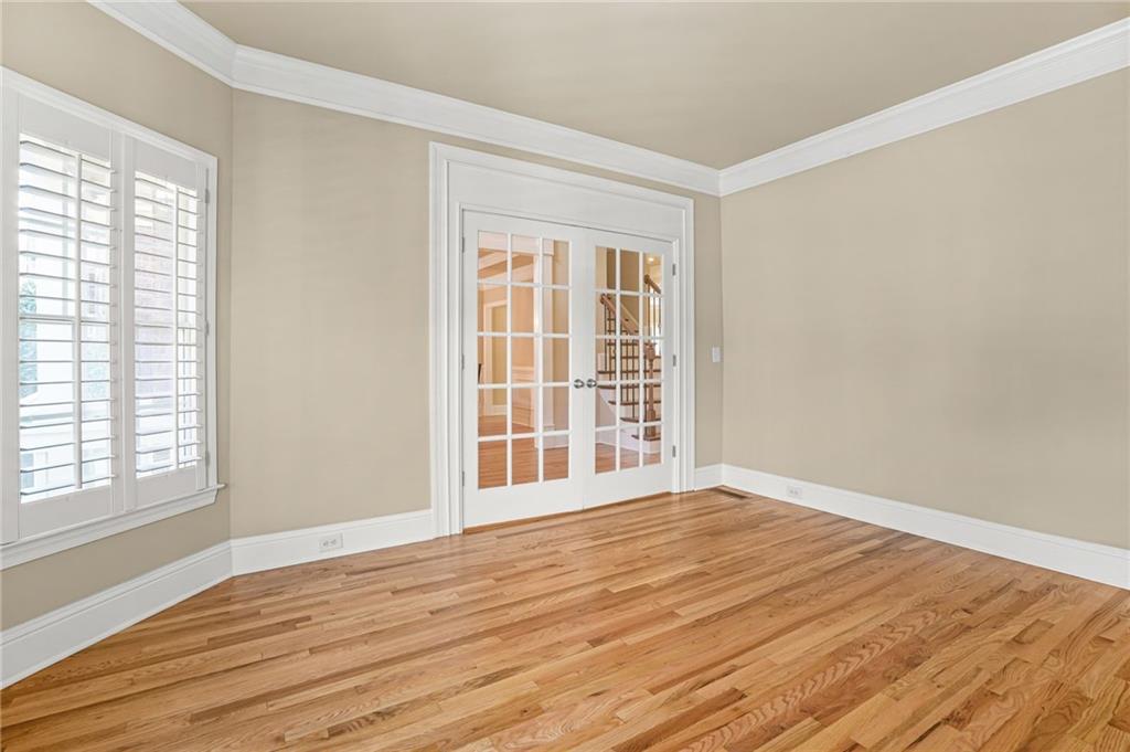 955 Gardiner Circle Suwanee, GA 30024 - Photo 5 of 44 a view of an empty room with wooden floor and a window