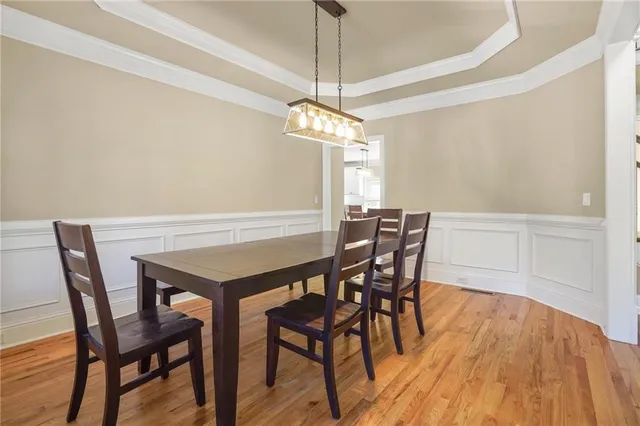 a view of a dining room with furniture and wooden floor