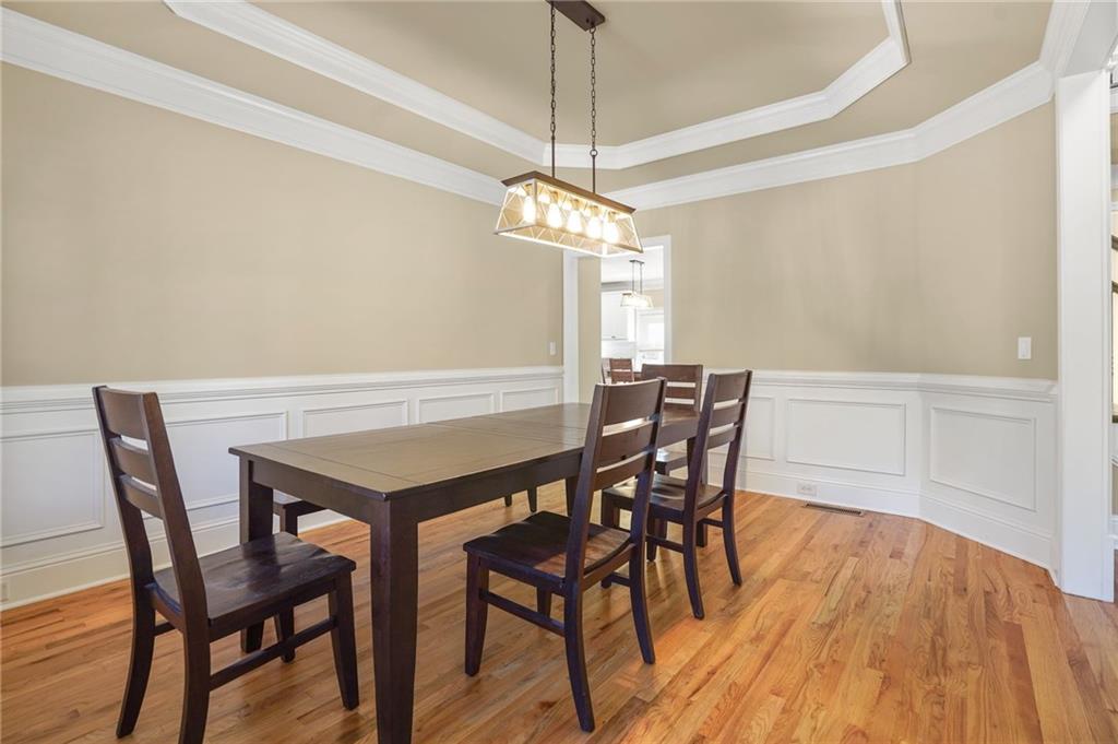 955 Gardiner Circle Suwanee, GA 30024 - Photo 6 of 44 a view of a dining room with furniture and wooden floor