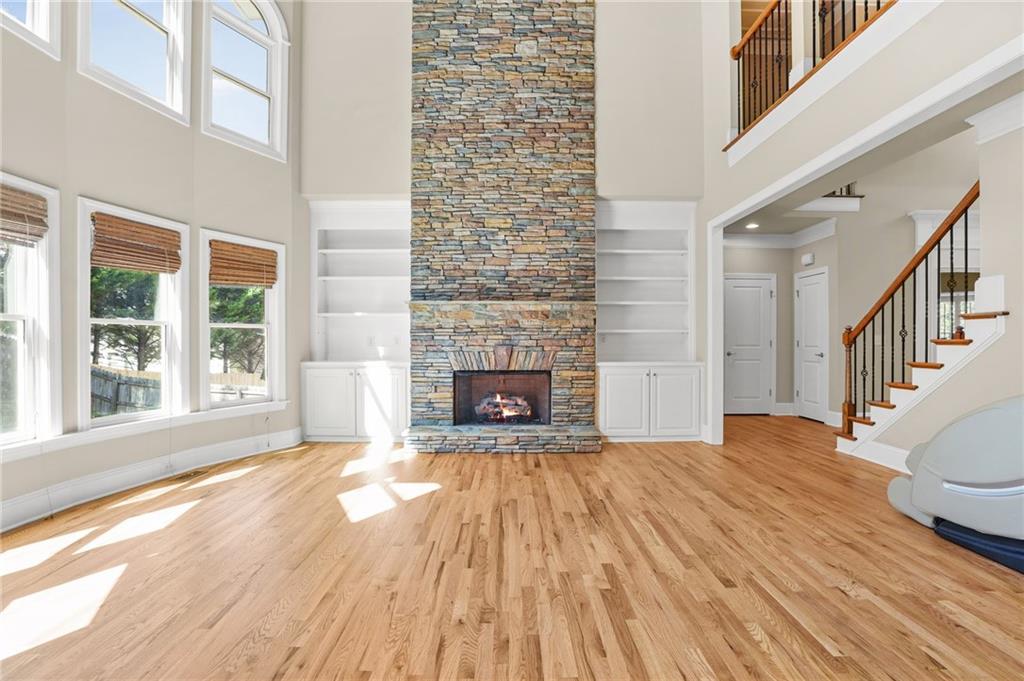 955 Gardiner Circle Suwanee, GA 30024 - Photo 9 of 44 a view of a livingroom with wooden floor and a fireplace