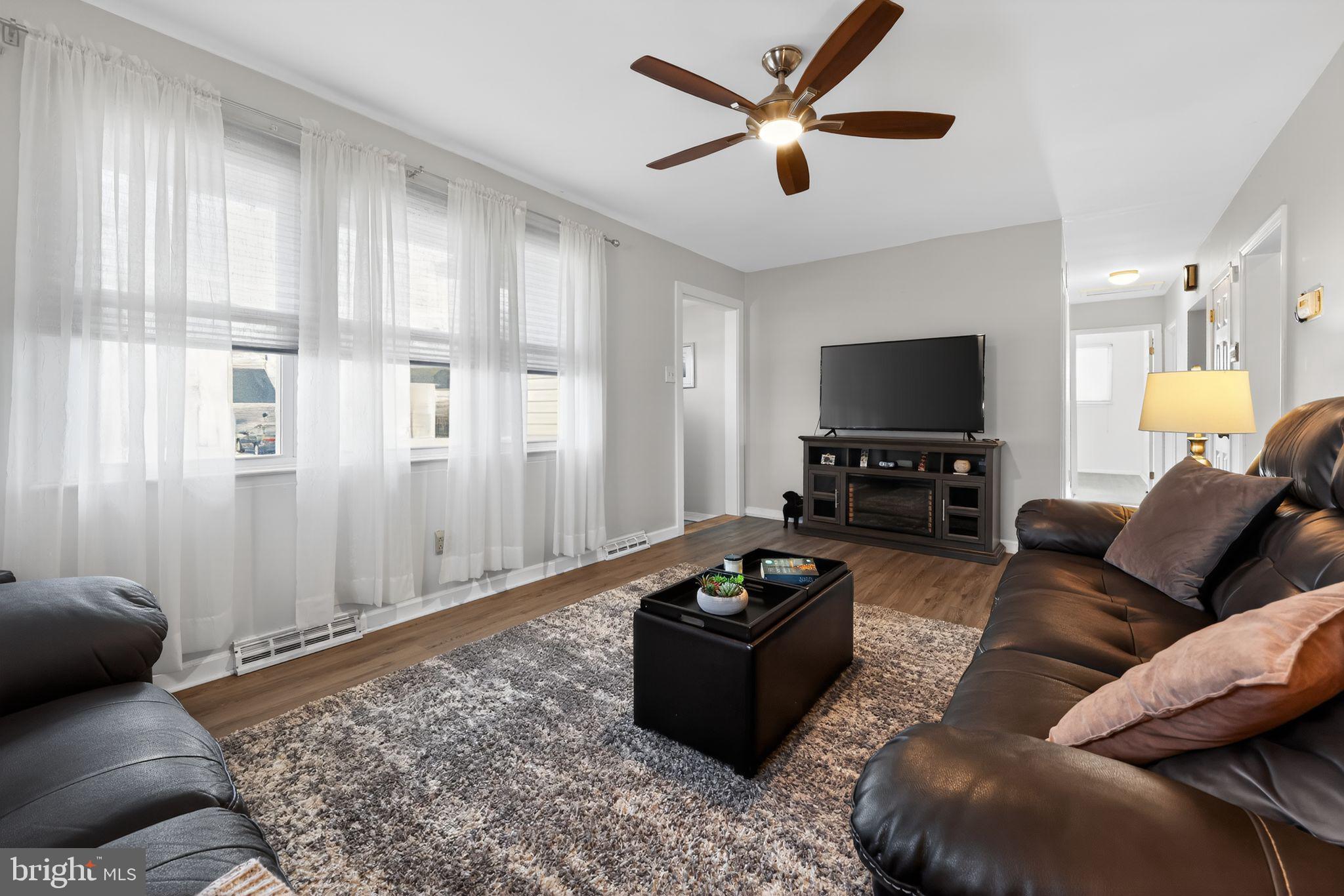 940 Carter Avenue Bellmawr, NJ 08031 - Photo 6 of 33 a living room with furniture a ceiling fan and a rug