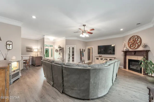 a living room with fireplace furniture and a flat screen tv