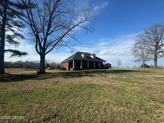 a yellow house in middle of the forest