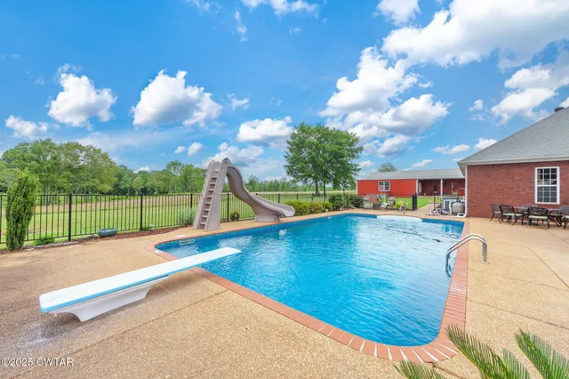 a view of a swimming pool with a yard