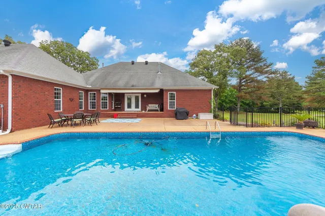 a view of a swimming pool with an outdoor seating