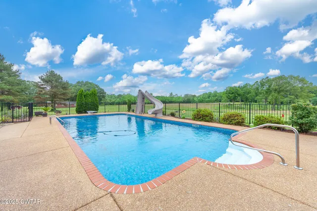 a view of a swimming pool with a patio
