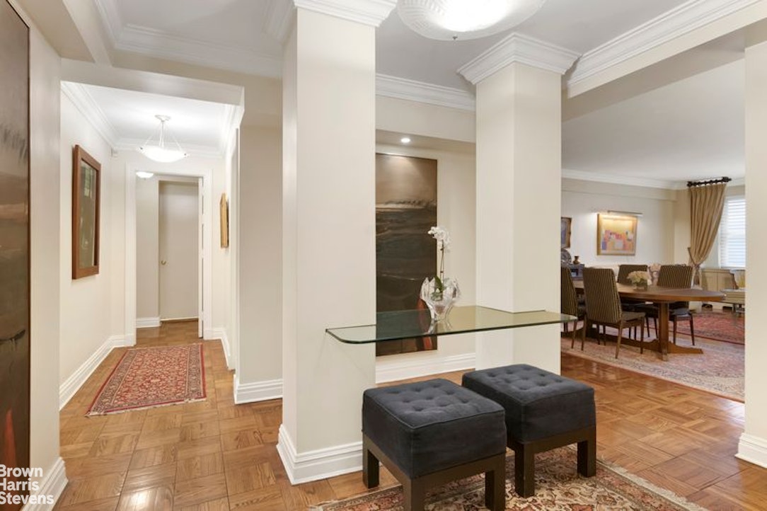 110 East 57th Street, Unit 4FG Manhattan, NY 10022 - Photo 1 of 9 a living room with furniture and a table