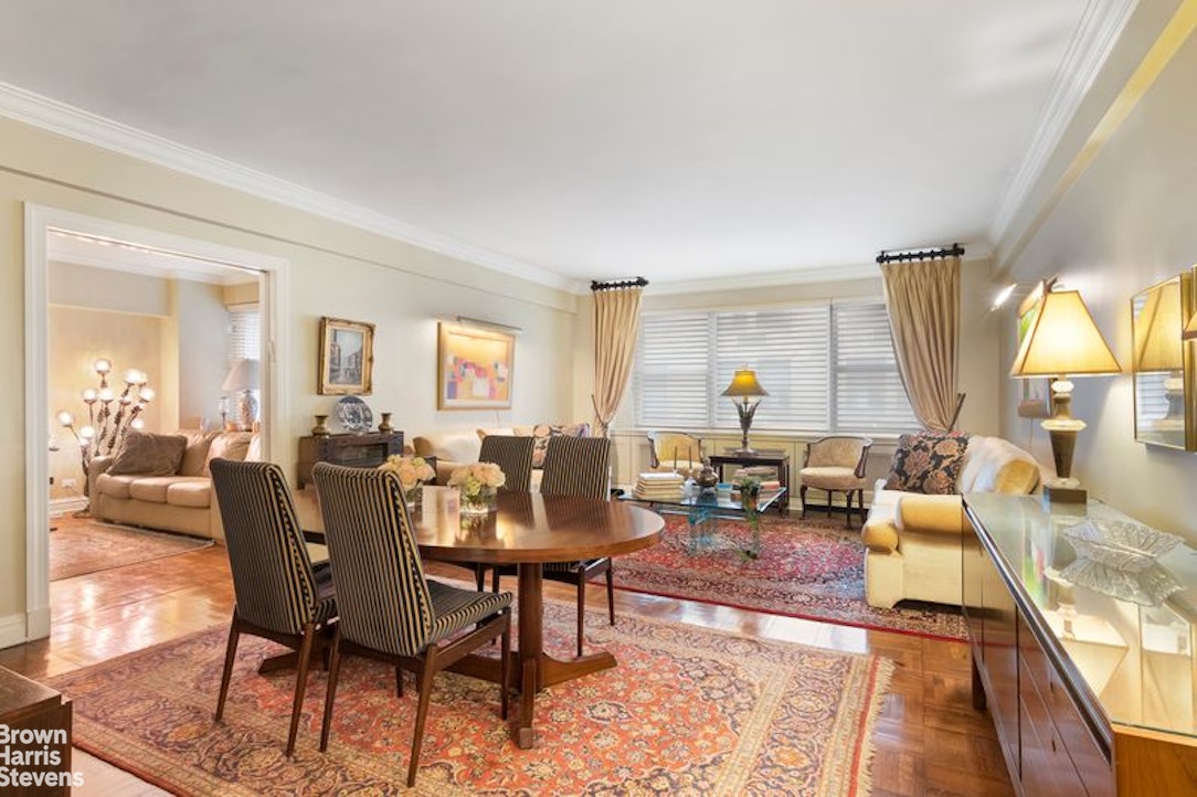 110 East 57th Street, Unit 4FG Manhattan, NY 10022 - Photo 2 of 9 a living room with furniture and a large window