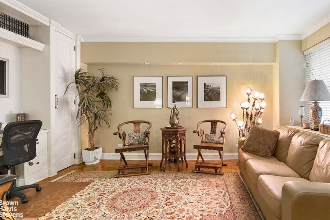 110 East 57th Street, Unit 4FG Manhattan, NY 10022 - Photo 3 of 9 a living room with furniture rug and a window
