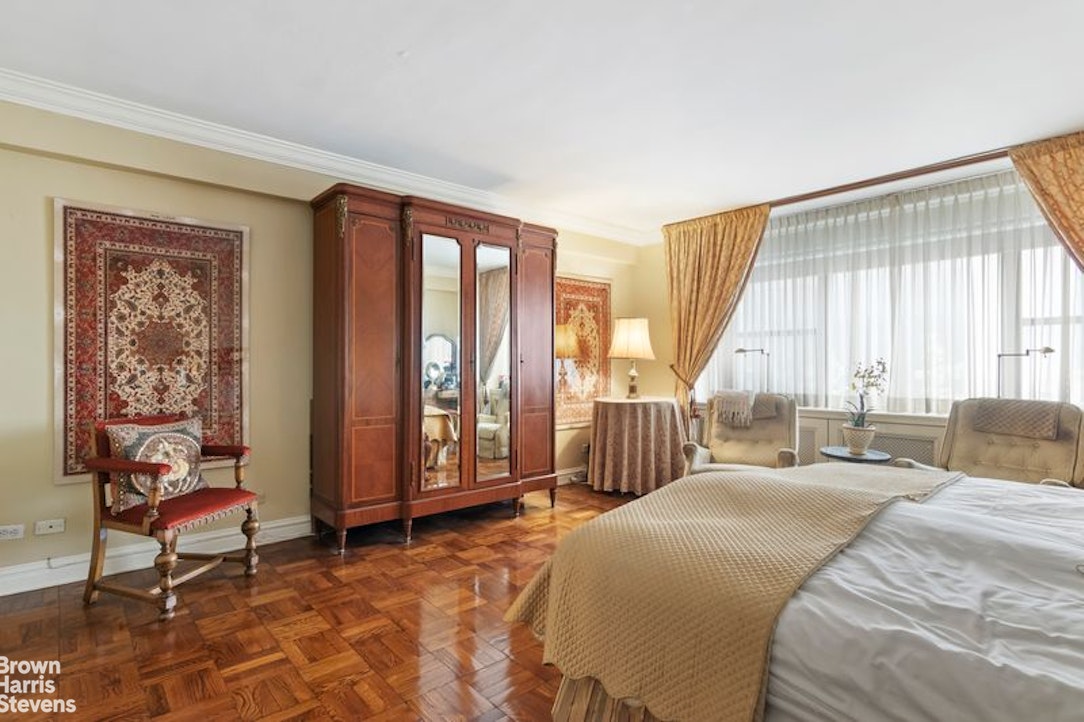 110 East 57th Street, Unit 4FG Manhattan, NY 10022 - Photo 4 of 9 a spacious bedroom with a bed and a large window