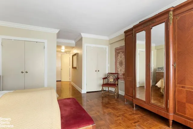 a spacious bedroom with a bed and a large window