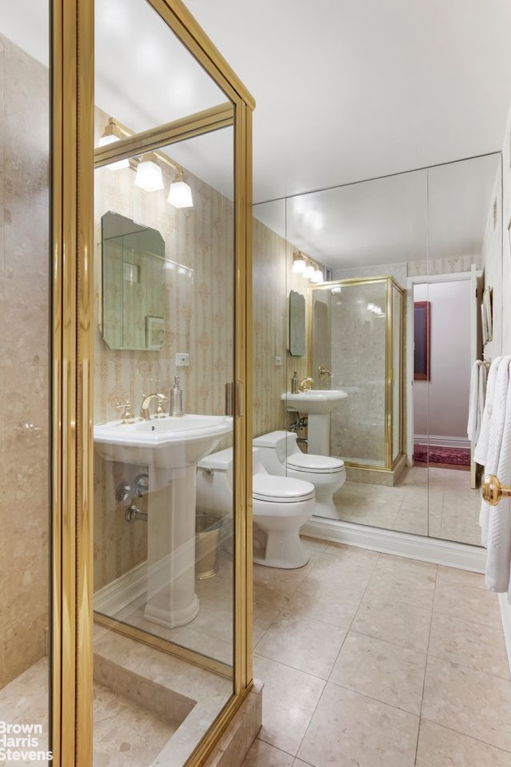 110 East 57th Street, Unit 4FG Manhattan, NY 10022 - Photo 8 of 9 a bathroom with a double vanity sink toilet and shower