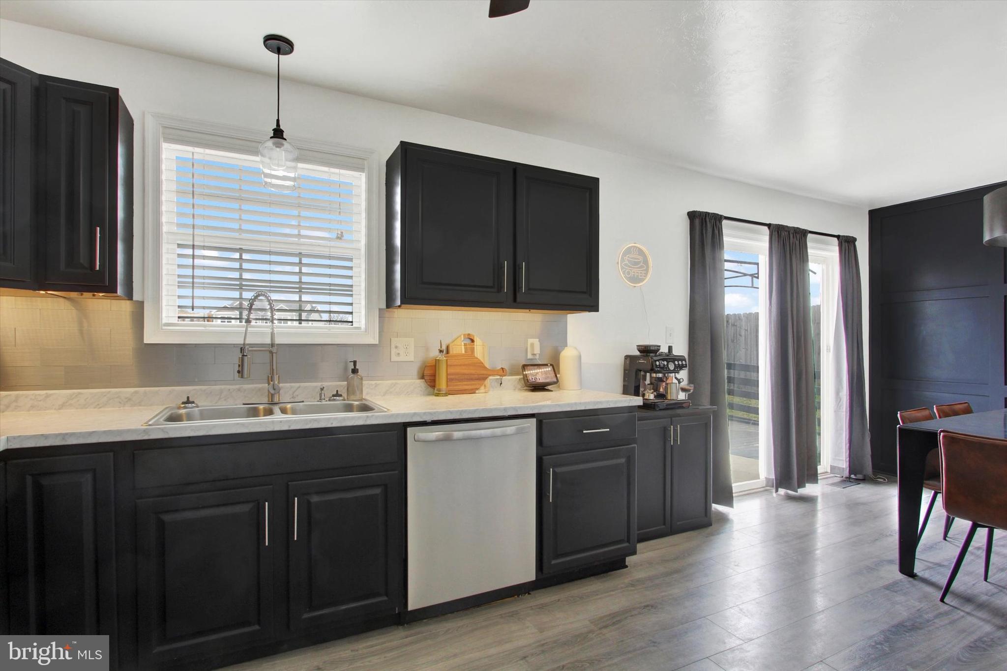 80 Galaxy Drive Hanover, PA 17331 - Photo 8 of 26 a kitchen with a sink stove and wooden cabinets