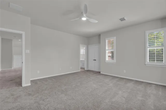 an empty room with windows and closet