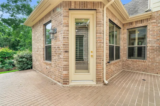 a view of a brick house with a large window