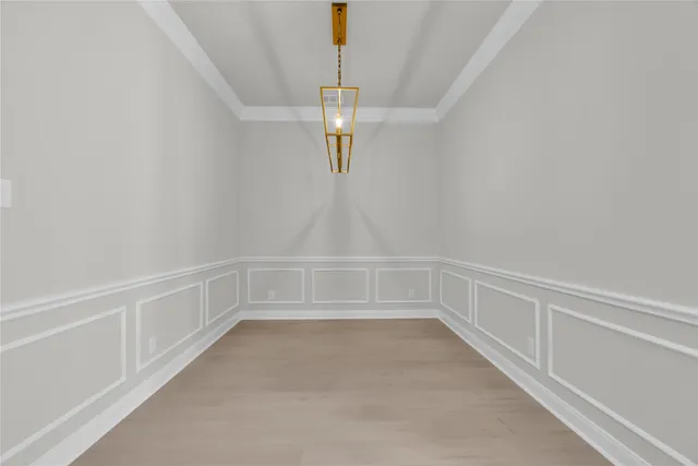 a view of an empty room with chandelier
