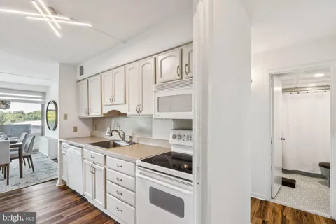 a kitchen with stainless steel appliances a sink stove and cabinets