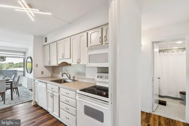 a kitchen with stainless steel appliances a sink stove and cabinets