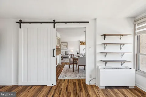 a view of a room with wooden floor and furniture