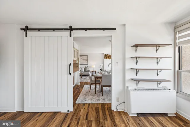 a view of a room with wooden floor and furniture