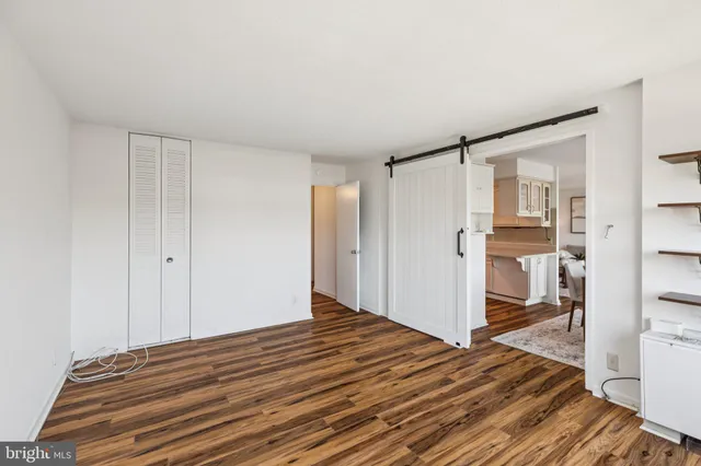 a view of a room with wooden floor