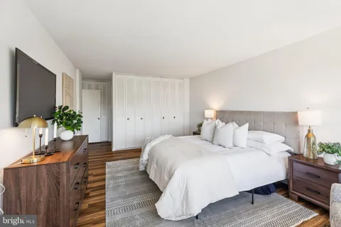 a bedroom with a bed and a potted plant