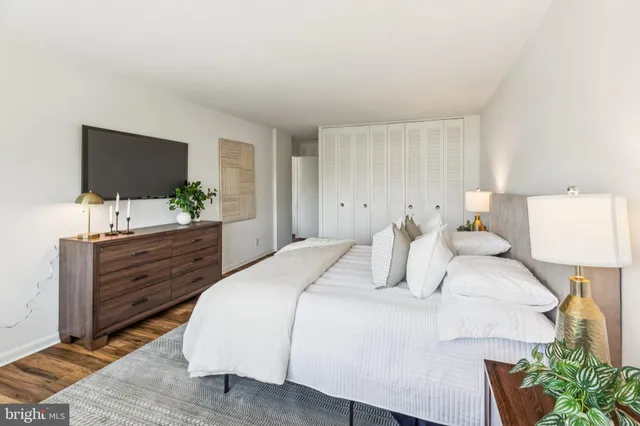 a bedroom with a bed and a flat screen tv