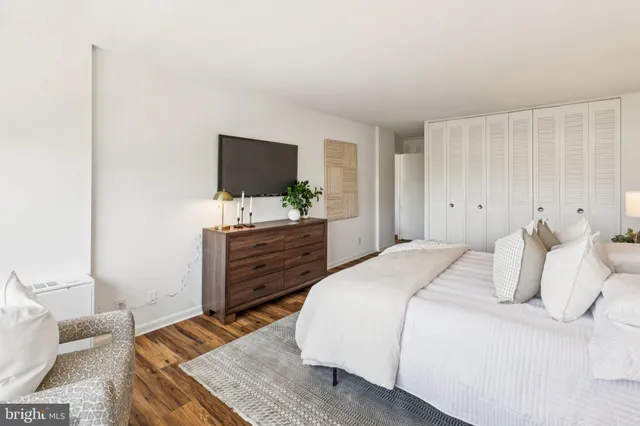 a bedroom with a bed and a flat screen tv