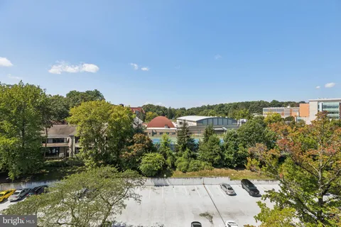a view of a city with lush green forest