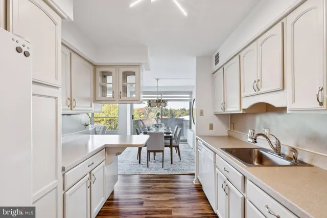 a kitchen with granite countertop a sink appliances cabinets and counter space