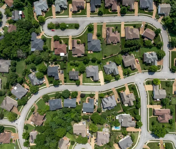 an aerial view of residential houses with outdoor space and street view