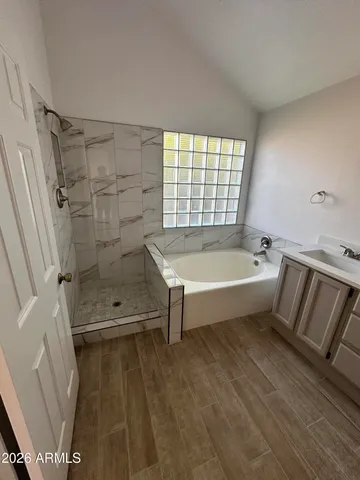 a bathroom with a bathtub and shower