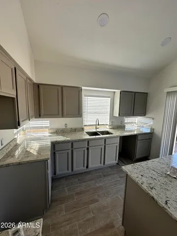 a kitchen with a sink and wooden cabinets